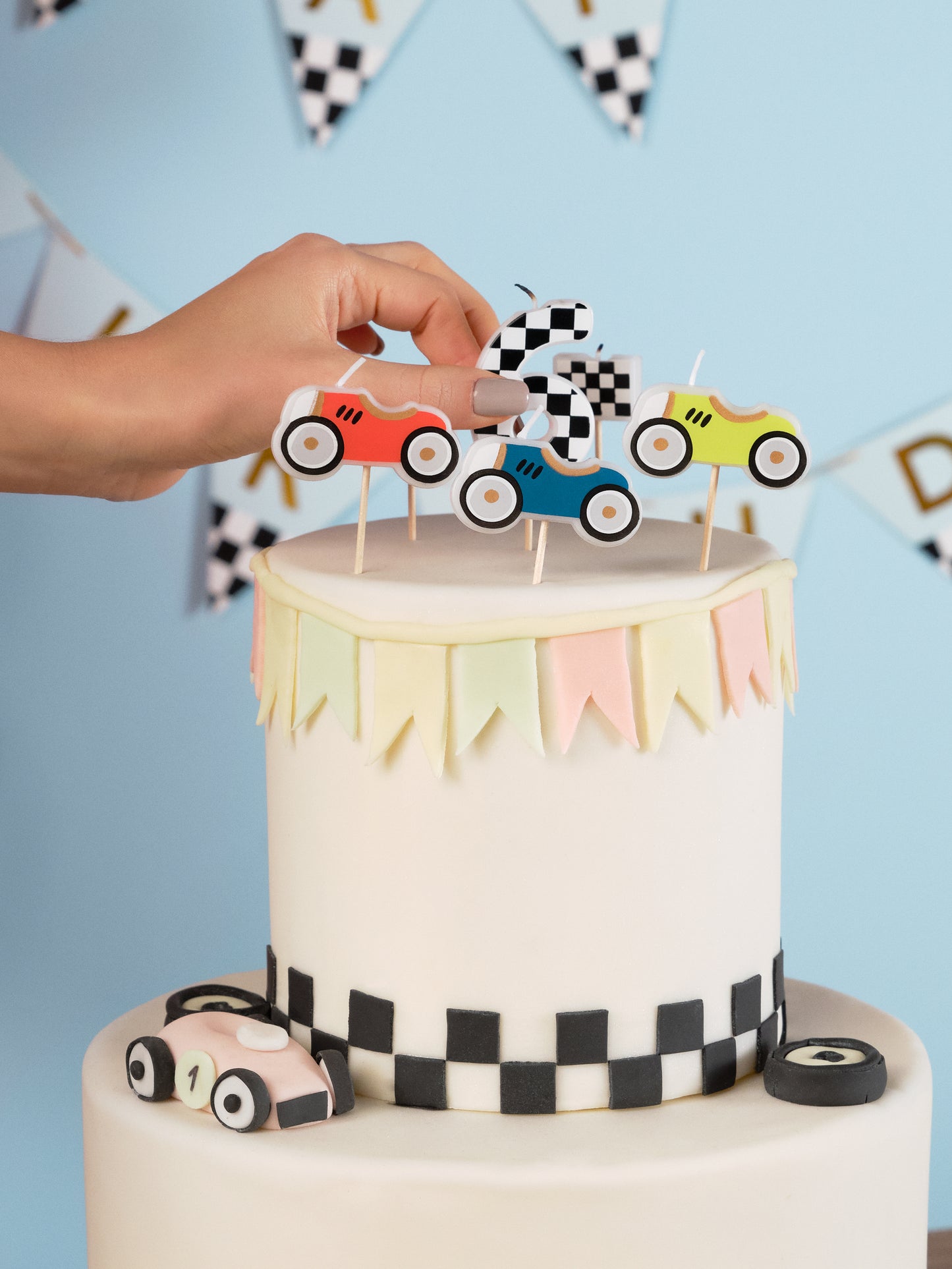 Colorful race car and checkered flag birthday candles.