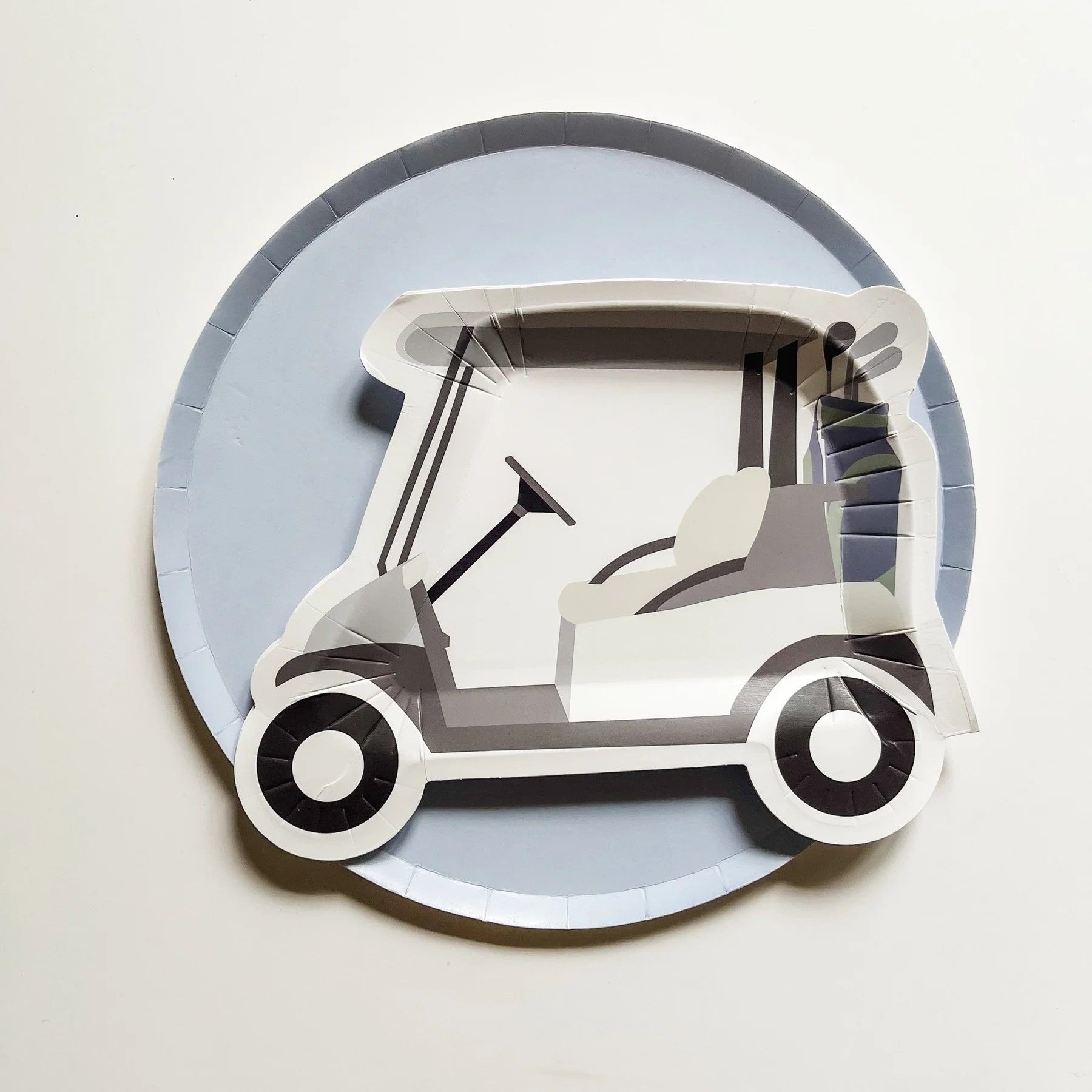 Paper plate with a golf cart design on a light gray background