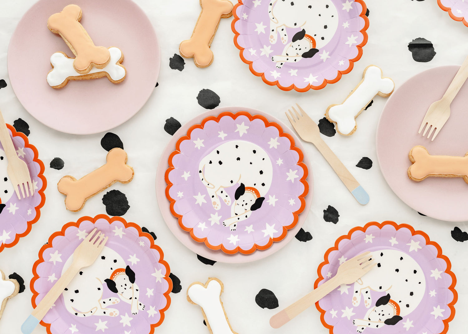 Kids' dog-themed birthday party with colorful garlands, dog foil balloons, paw print balloons, dog-themed tableware and happy children enjoying the fun decor