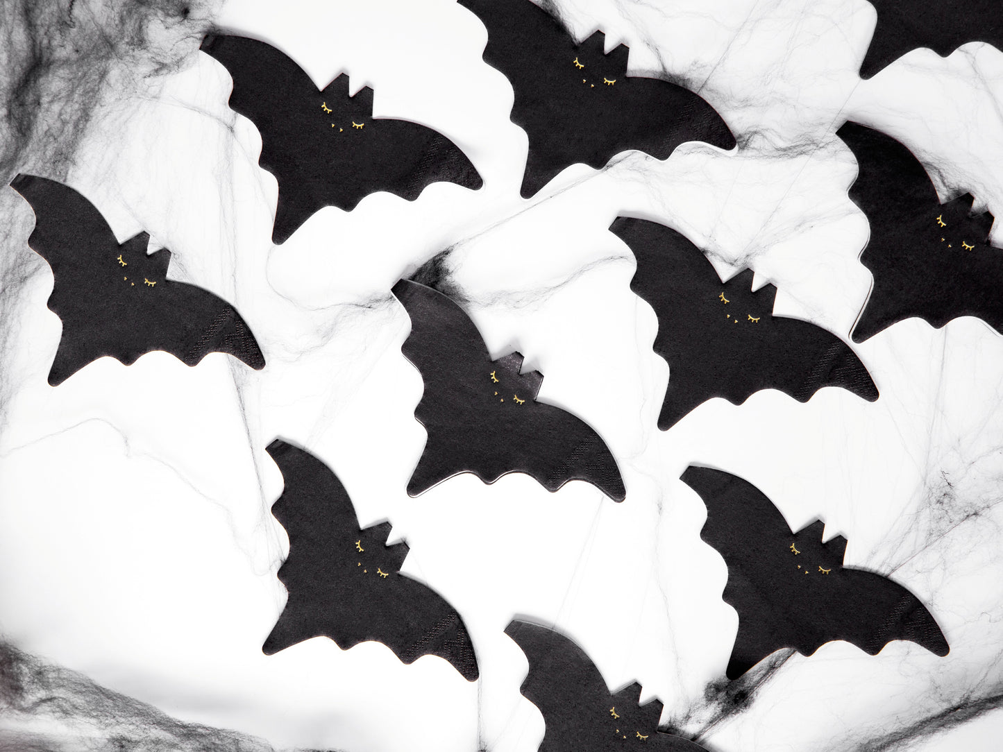 Black bat-shaped napkins on a white background