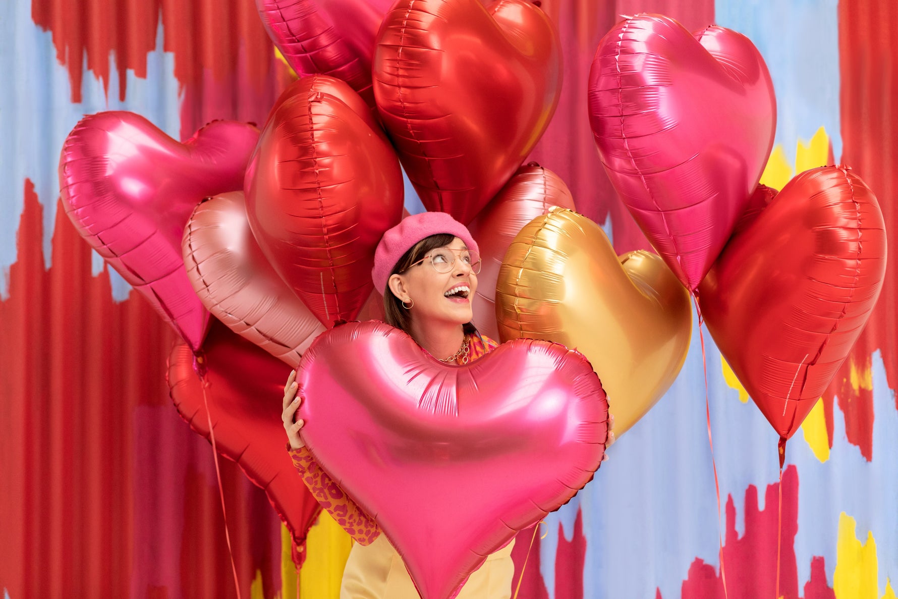 Woman holding heart-shaped balloons