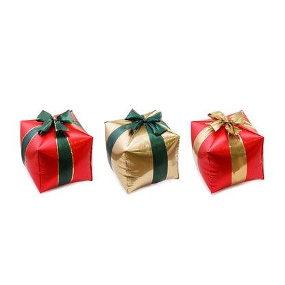 Three inflatable gift boxes in red, gold, and green with ribbons on a white background