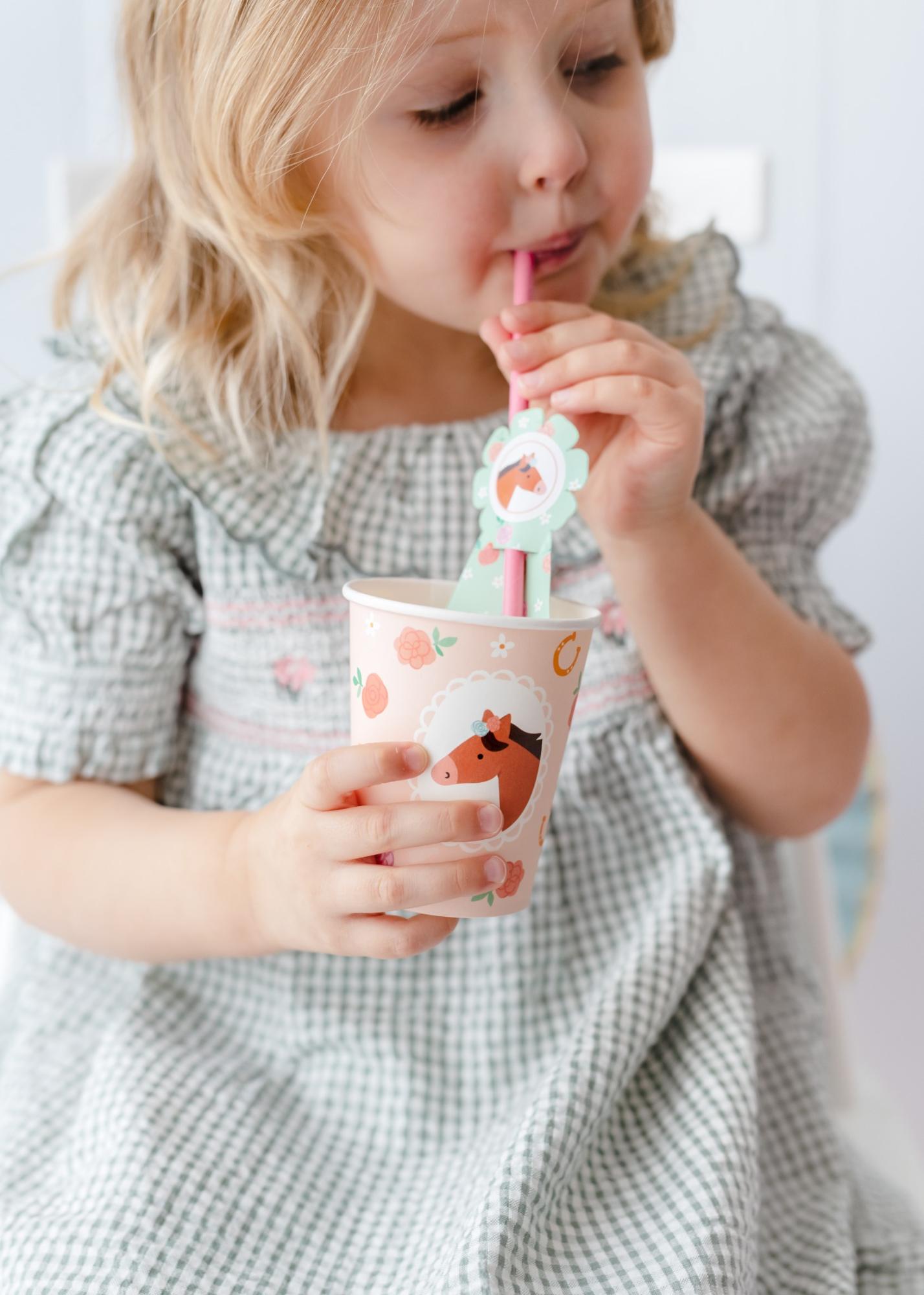 Paper cups and straws with horse toppers for kids birthday drinks