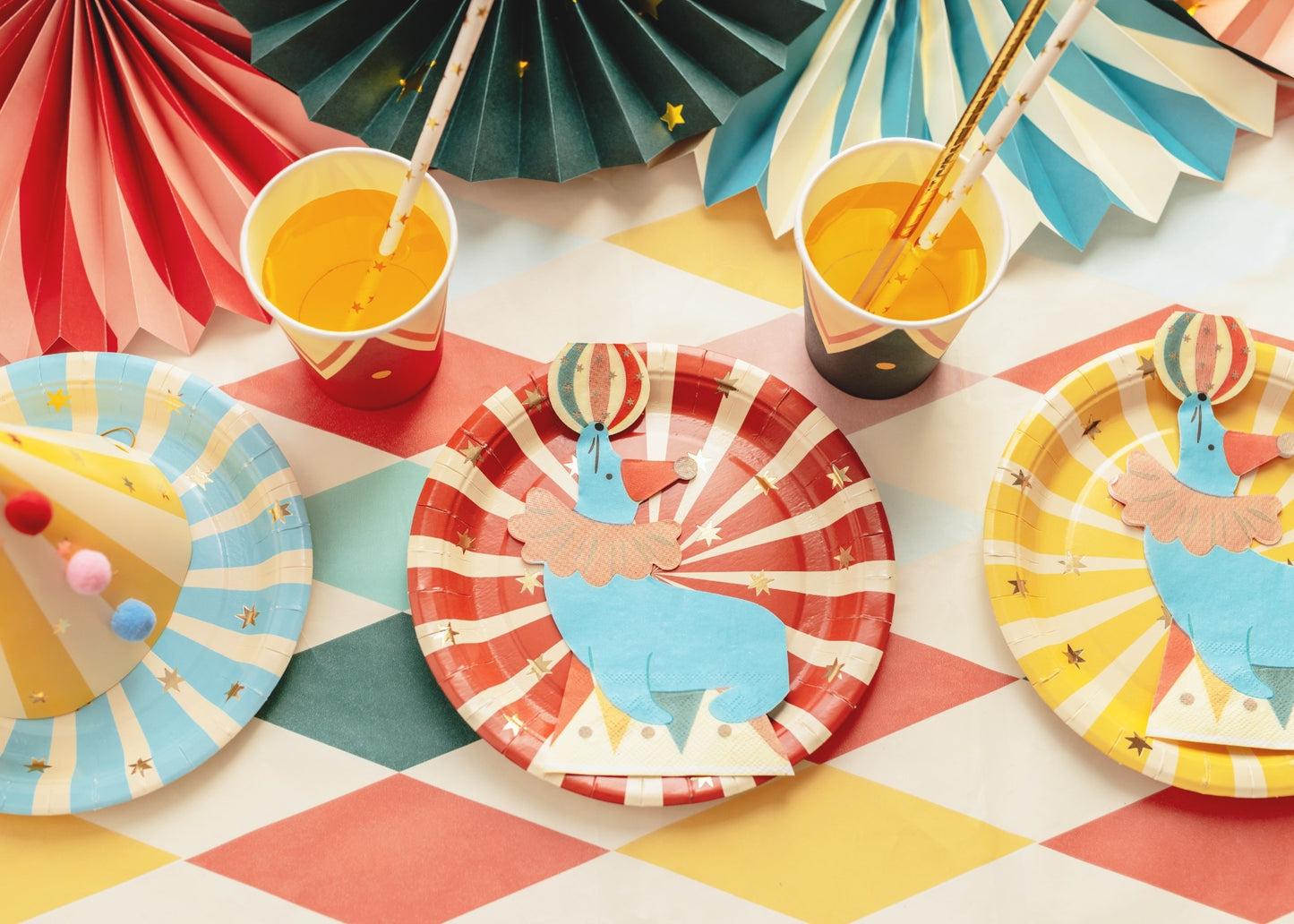 Decorative napkin shaped like a blue circus seal balancing a colorful ball on its nose