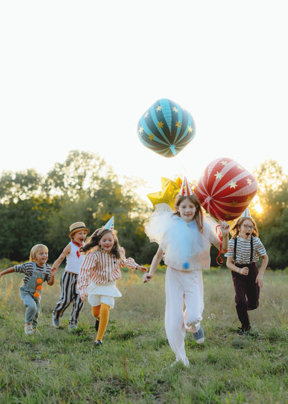 Round green and red foil balloon with vertical turquoise stripes and decorated with golden stars