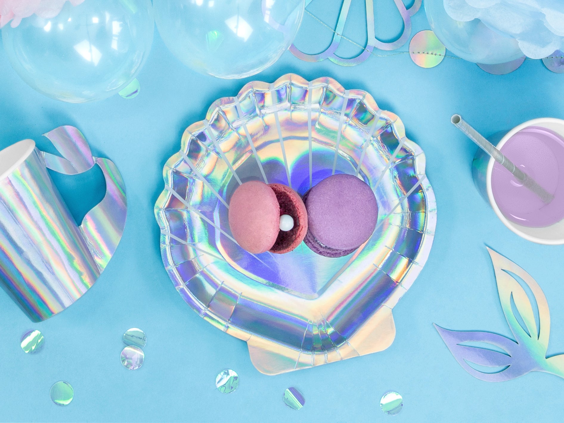 Iridescent paper plates shaped like seashells — perfect for mermaid or under the sea birthday parties.