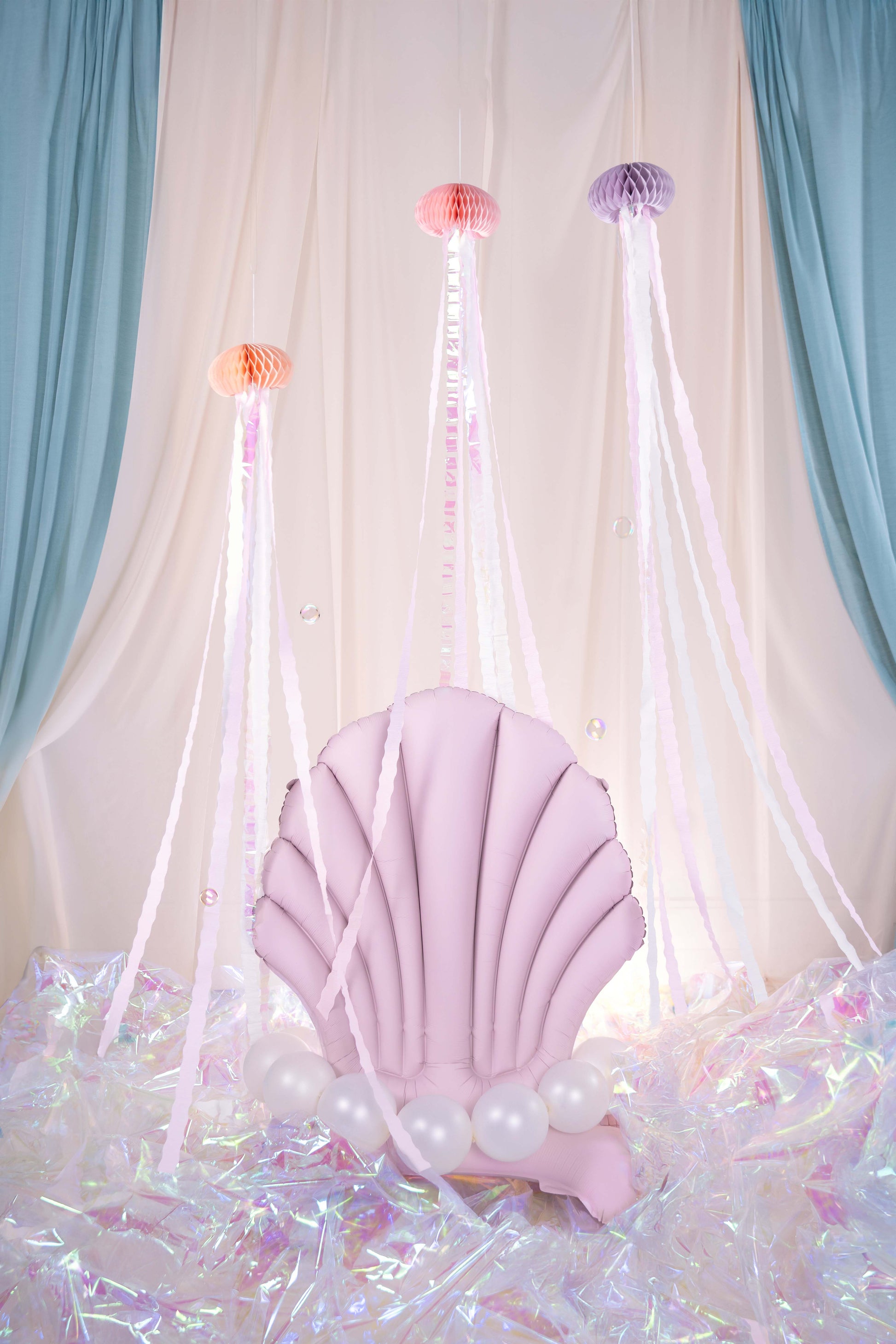 Pink foil balloon shaped like a seashell — elegant ocean or mermaid party decoration.