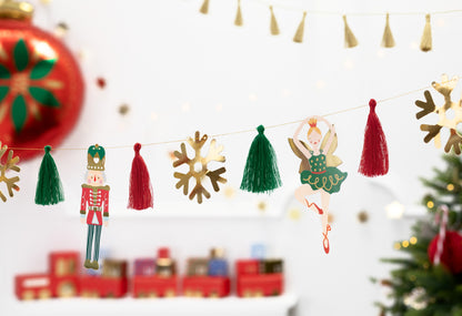 Decorative Christmas garland with tassels and figurines on a white background