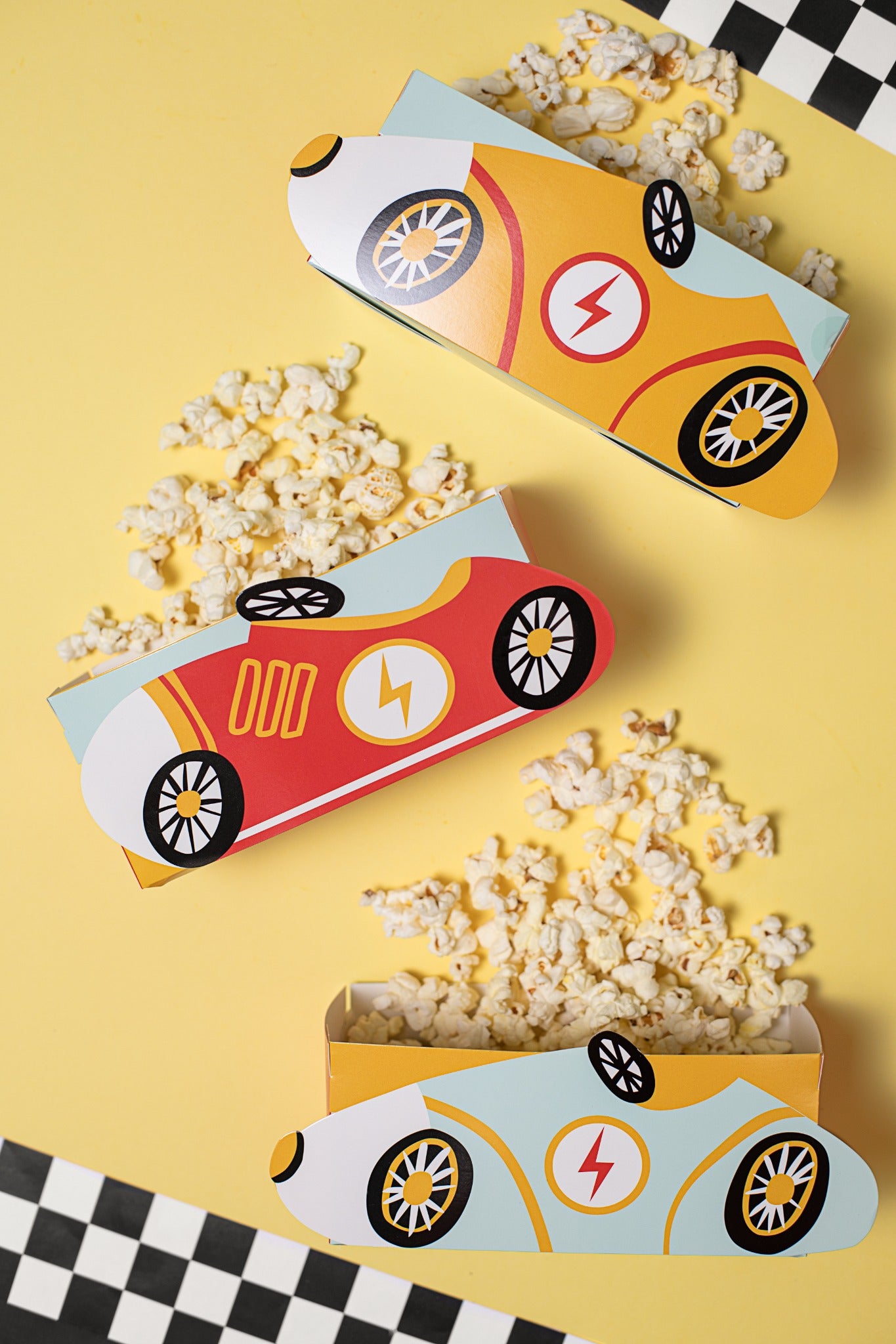 Snack boxes shaped like colorful race cars.
