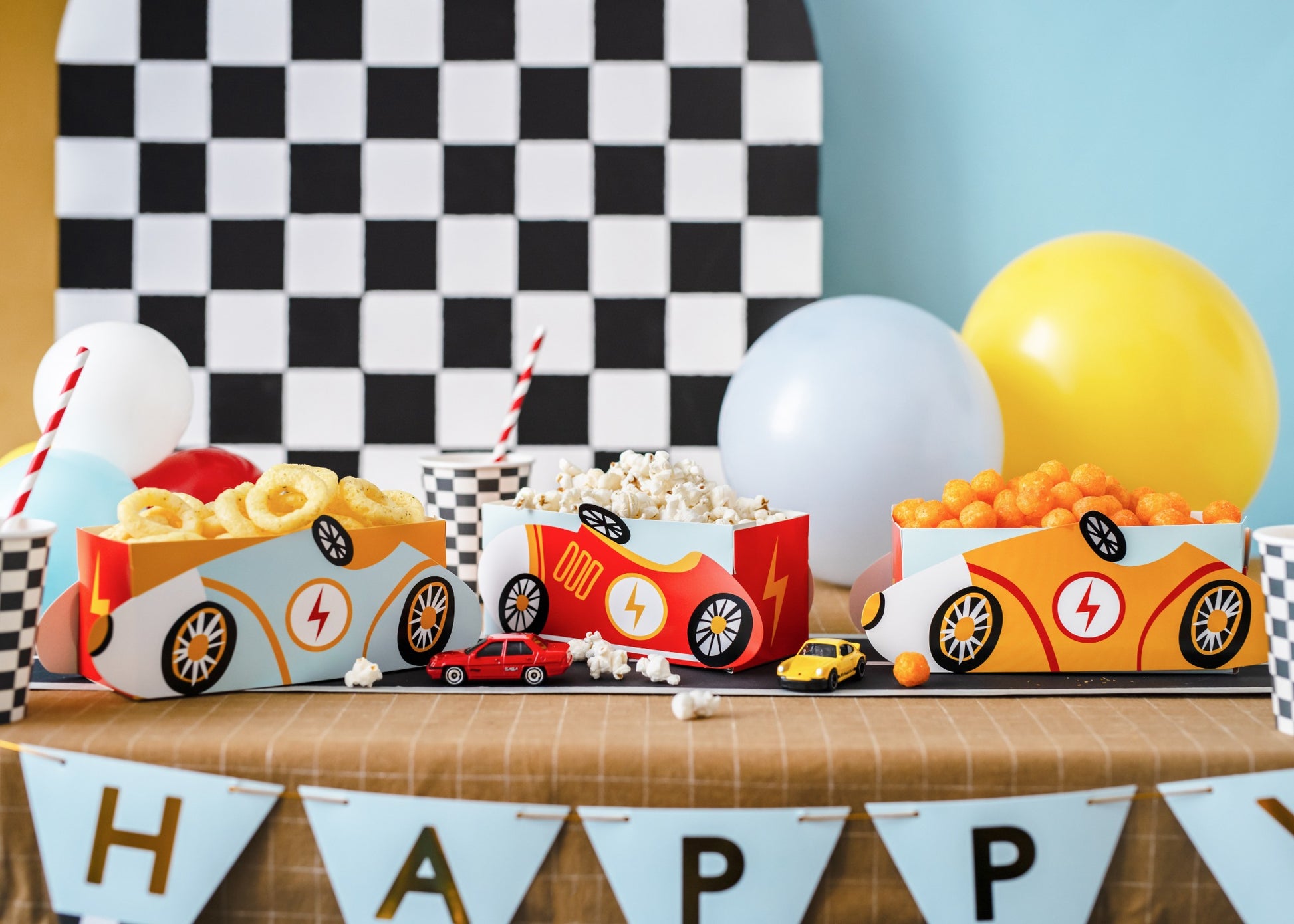 Snack boxes shaped like colorful race cars.