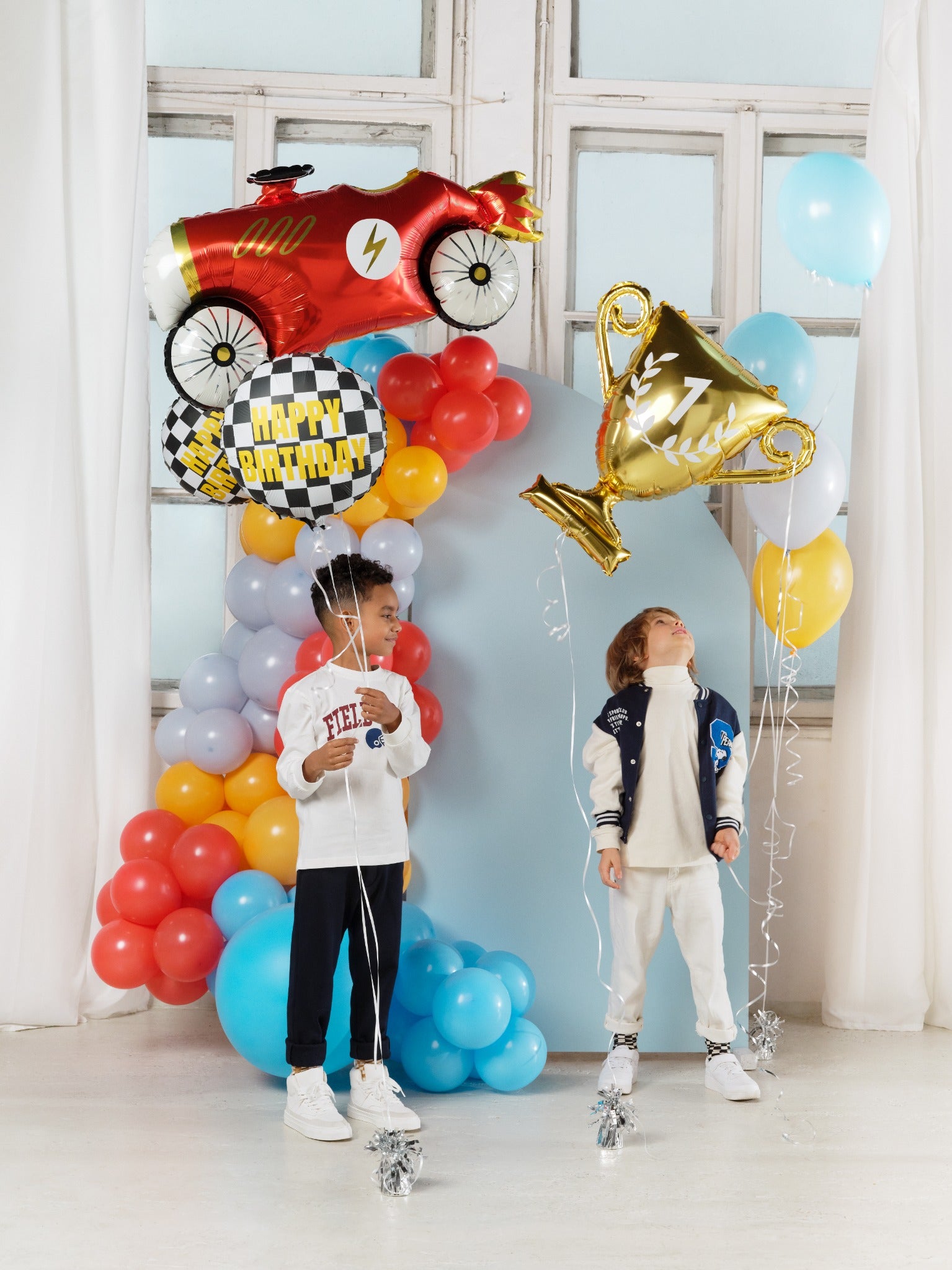 Foil balloon with checkered pattern and "Happy Birthday" text.