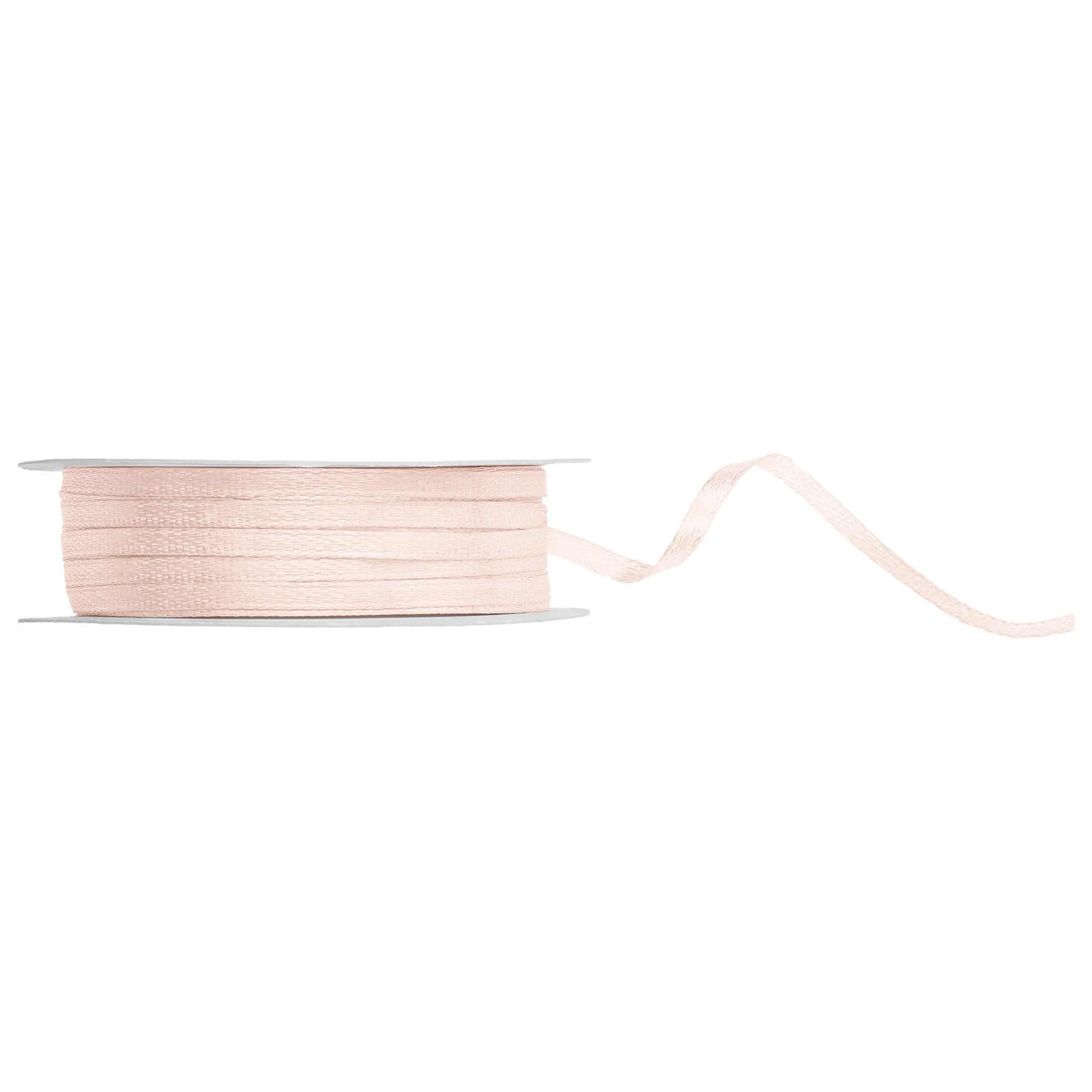 Spool of beige ribbon on a white background