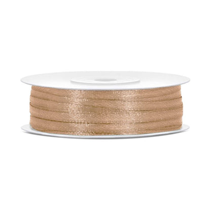 Spool of gold thread on a white background
