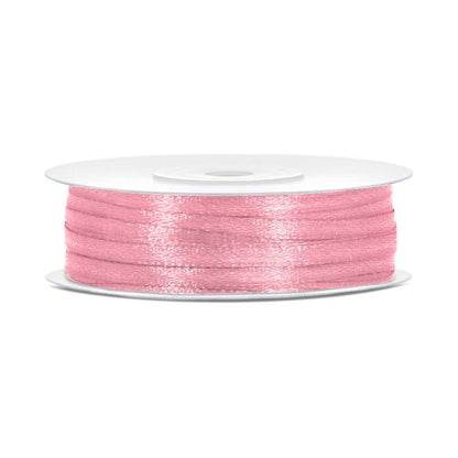 Spool of light pink thread on a white background