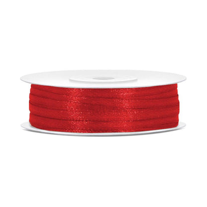 Spool of red thread on a white background