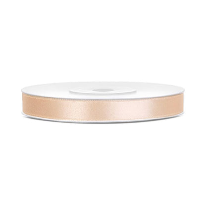 Spool of beige ribbon on a white background