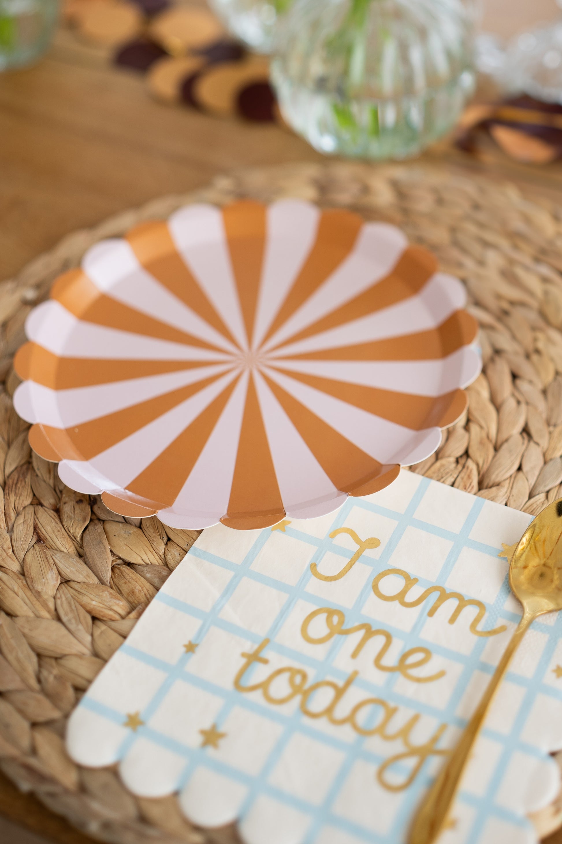 Round paper plates with mustard and blush pink stripes, fun and colorful party tableware