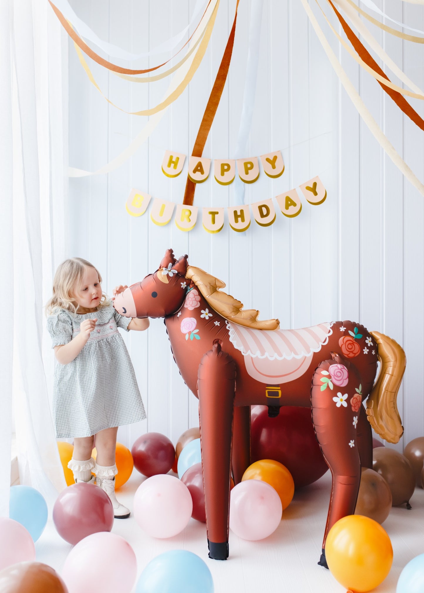 Large standing foil horse balloon with floral design for kids birthday party
