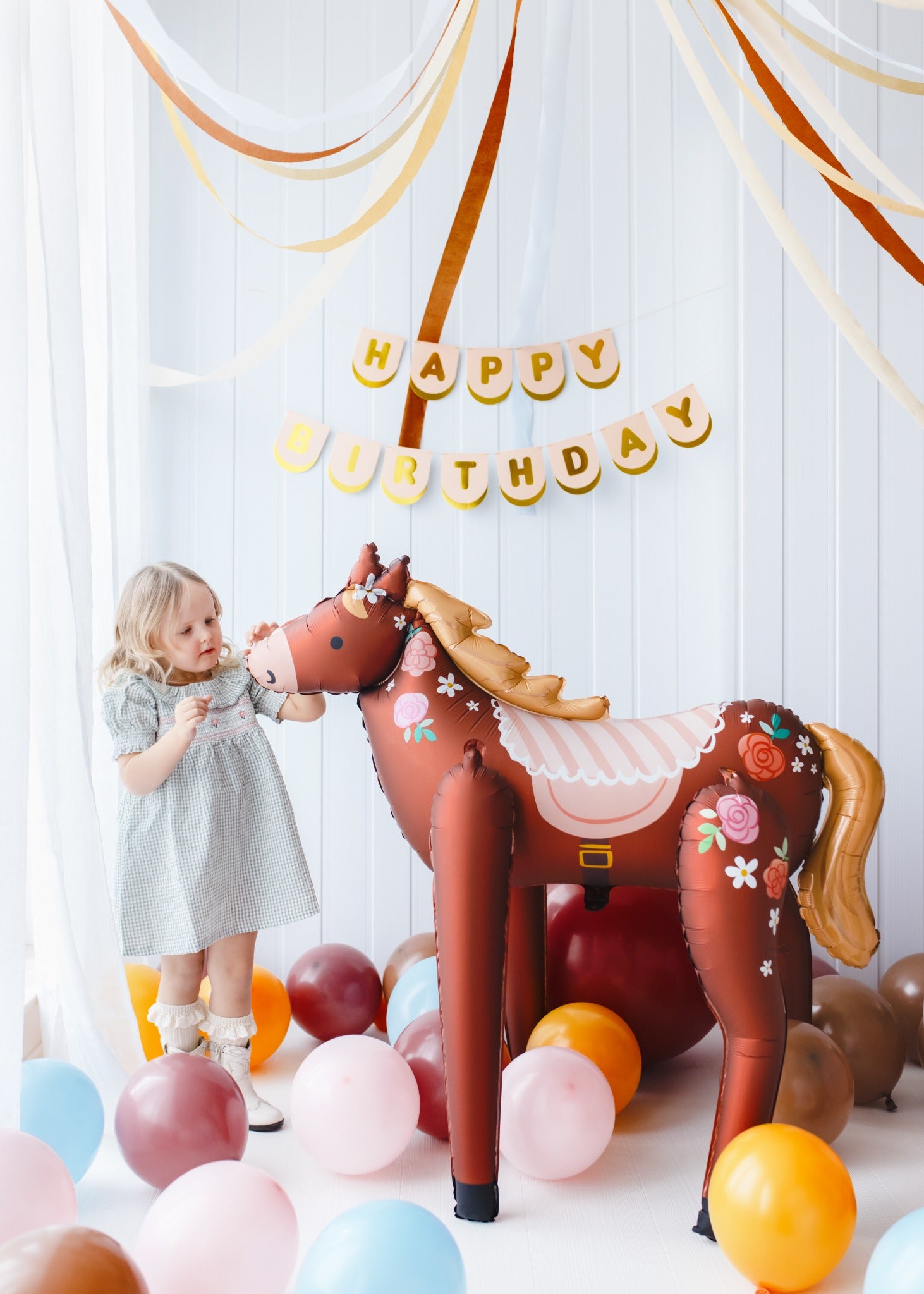 Large standing foil horse balloon with floral design for kids birthday party
